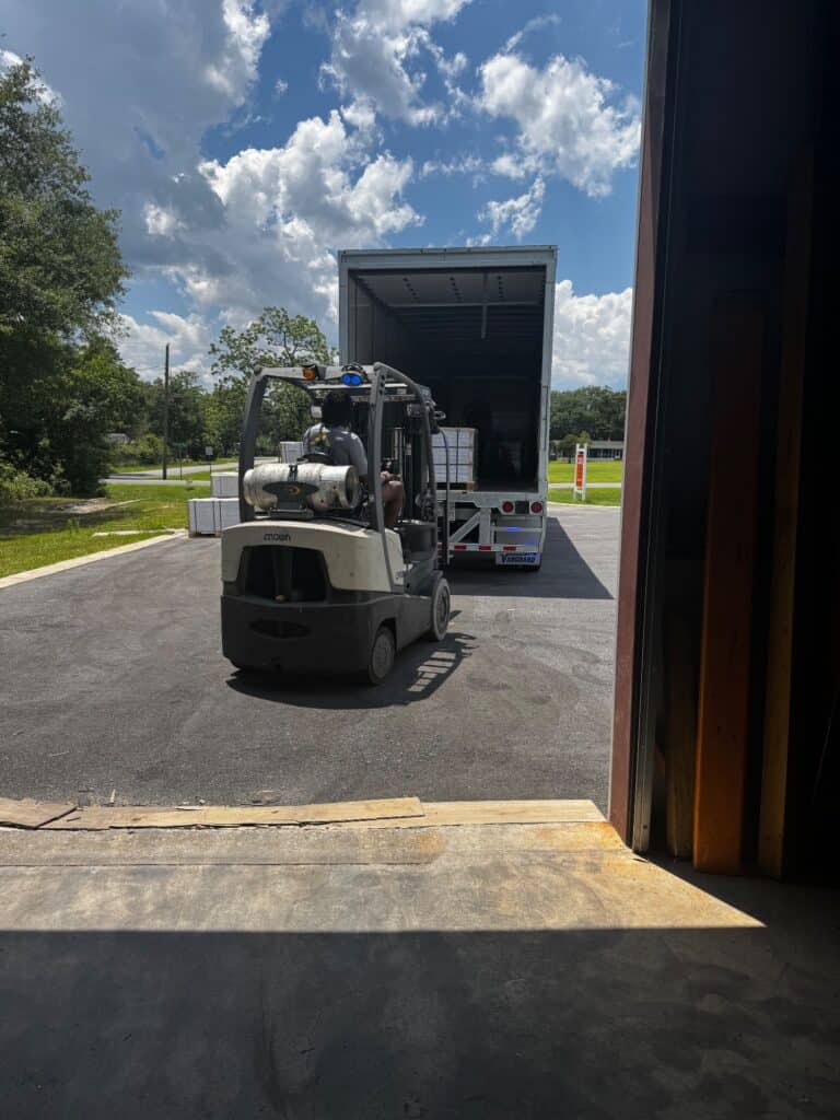 In-stock luxury vinyl plank flooring pallets at the Case Floors warehouse in Pace, FL
